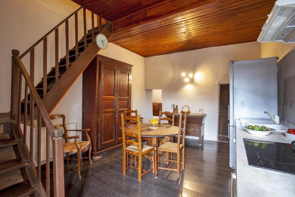 a kitchen and dining room with a table and a staircase at Casuccia in Santo-Pietro-di-Tenda