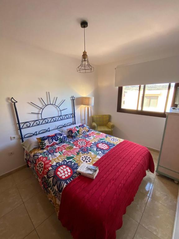 - une chambre avec un lit doté d'un couvre-lit rouge dans l'établissement Marea La Caleta El Hierro, à La Caleta