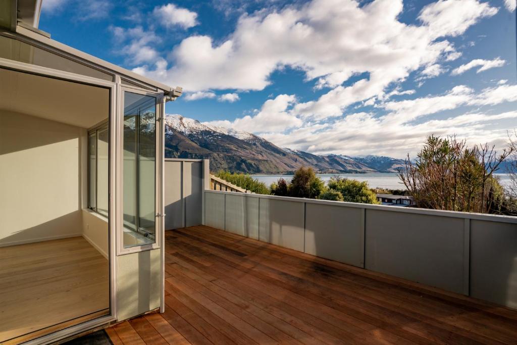 a balcony with a view of the water and mountains at Lakeview in Lake Hawea