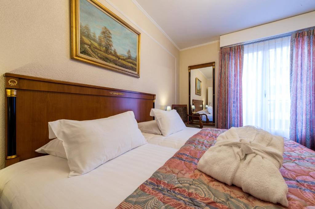Postel nebo postele na pokoji v ubytování Hotel Diplomate