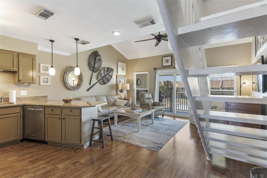 a kitchen and living room with a spiral staircase at 8 G Two Bedroom Condo in Destin