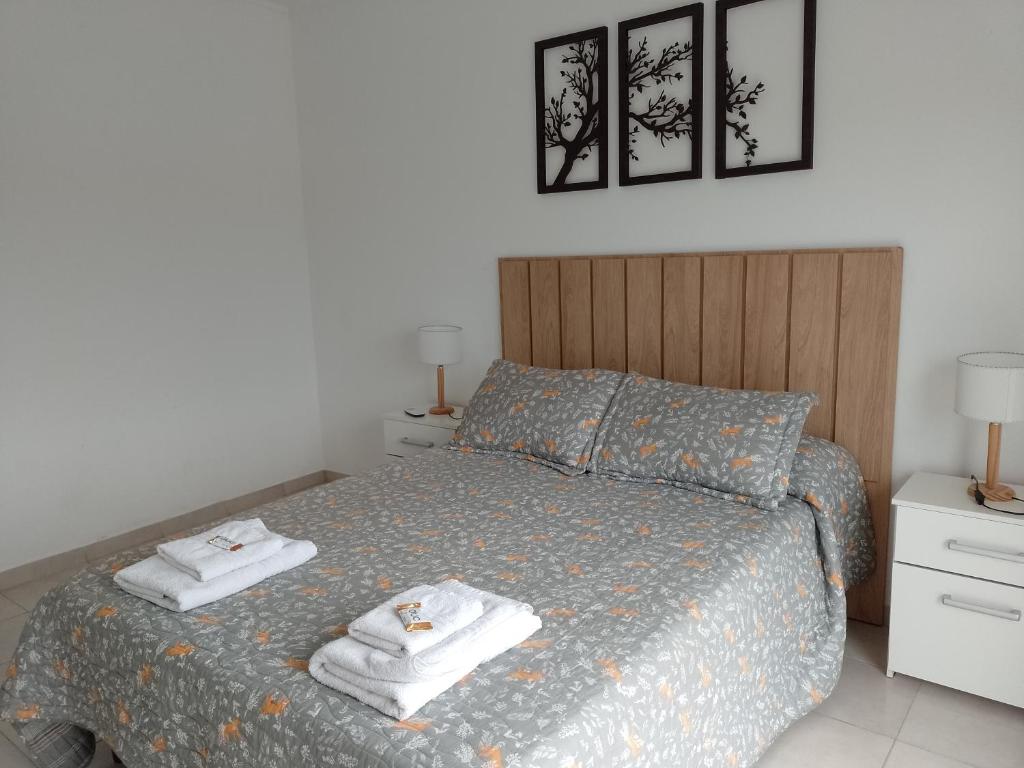 a bedroom with a bed with towels on it at Alojamientos Litoral - 3A in Gualeguaychú
