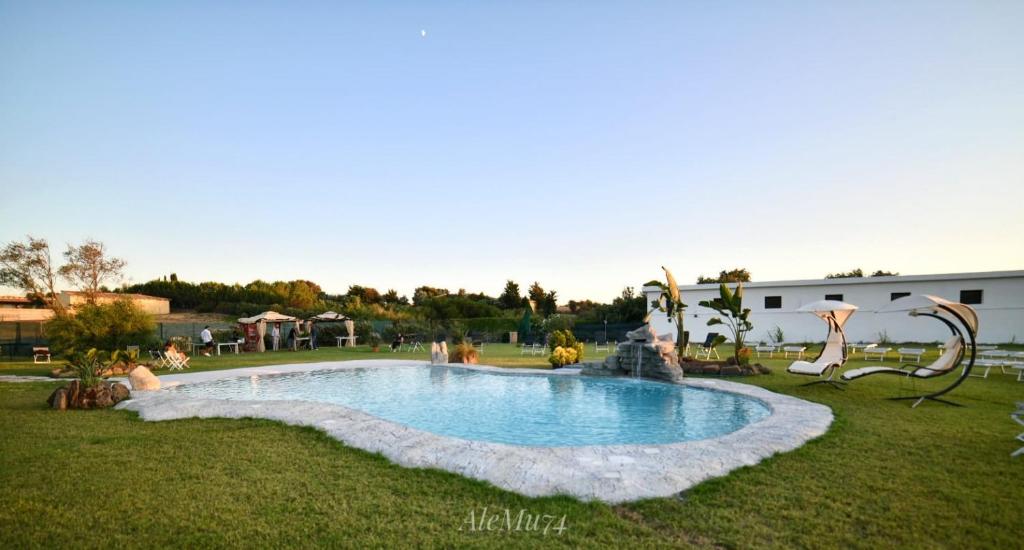 a swimming pool in the middle of a yard at Agriturismo Santa Lucia in Tratalias
