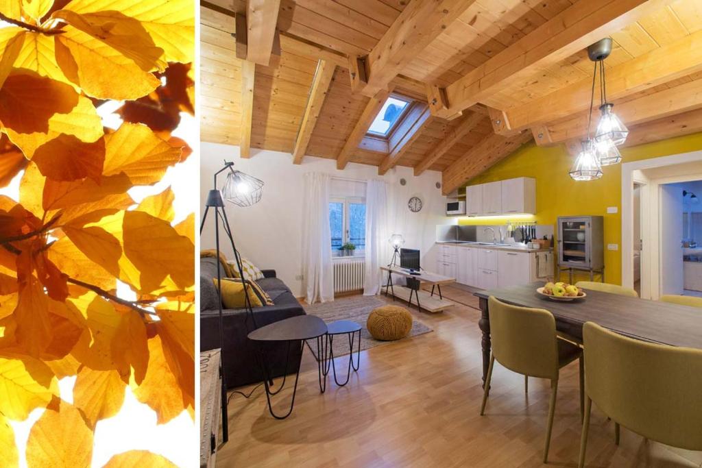 una cucina e un soggiorno con tavolo e sedie di La Casa di Trento a Trento