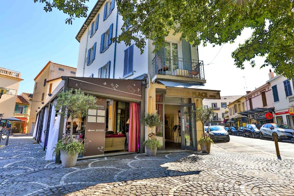 a street with a building on the side of the road at La Place Boutique Hotel in Antibes