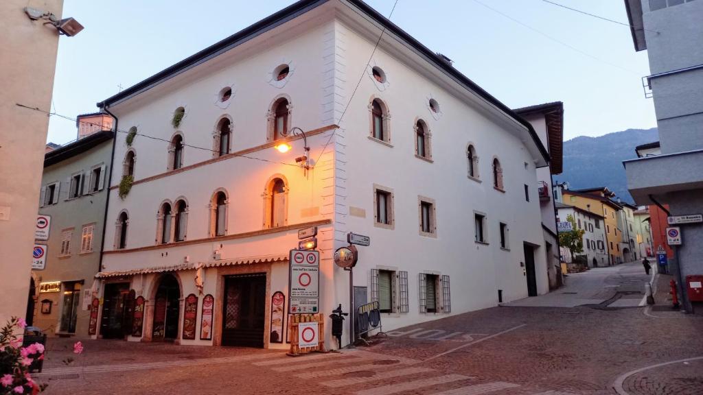 un bâtiment blanc sur le côté d'une rue dans l'établissement Antica Dimora, à Levico Terme