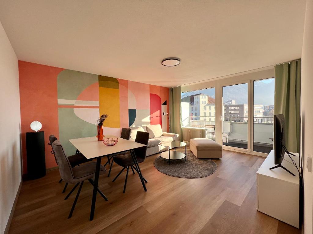 a living room with a table and a couch at Apartment Popular in Dornbirn