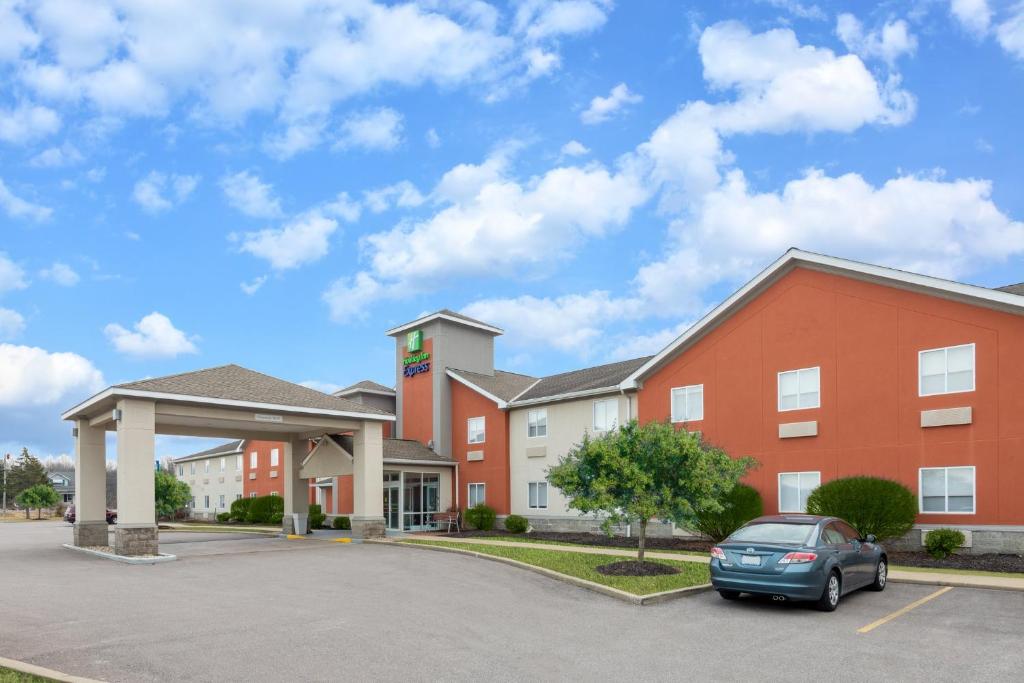 a hotel with a car parked in a parking lot at Holiday Inn Express Cleveland - Vermilion, an IHG Hotel in Vermilion