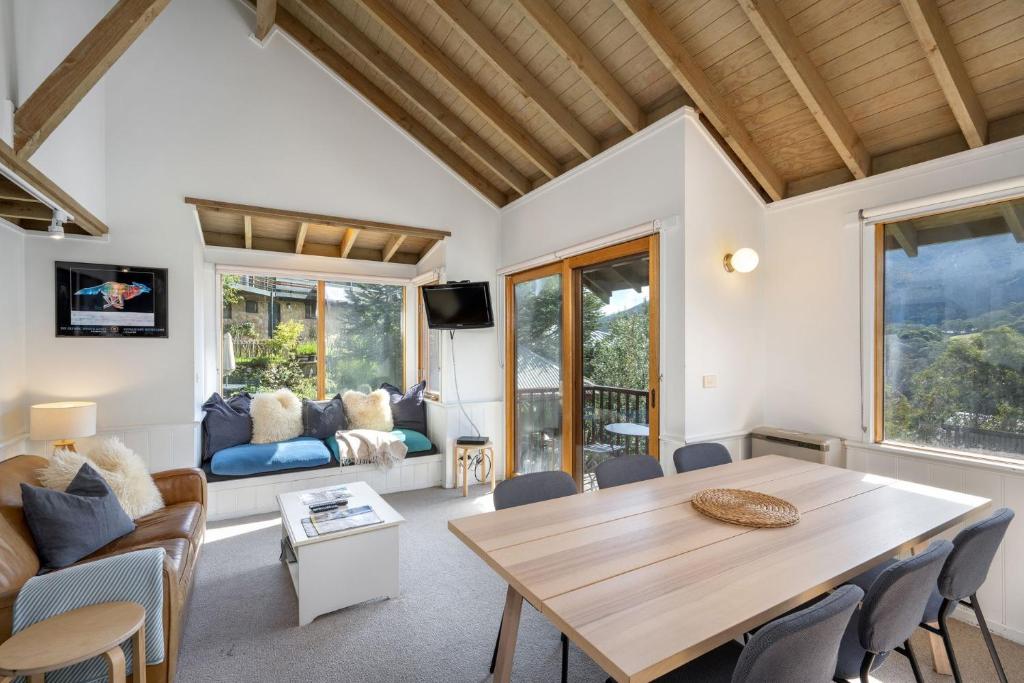 a living room with a wooden table and chairs at Banjo 7 Townhouse in Thredbo