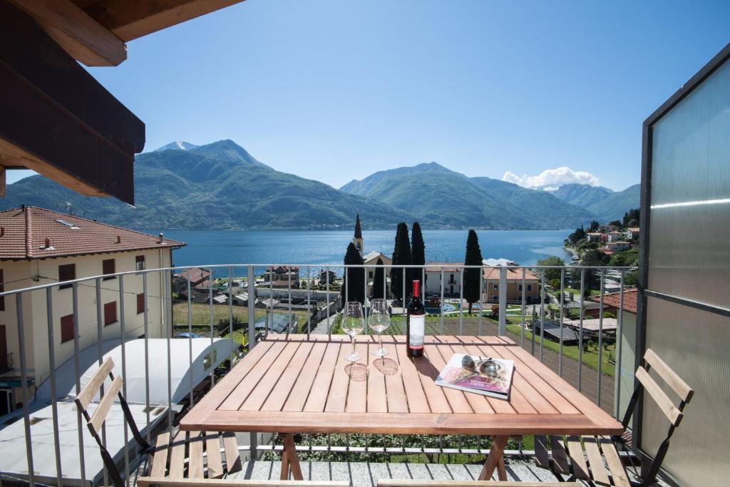 a table on a balcony with a view of a lake at Casa del Sole - sleeps 4 with shared pool in Pianello Del Lario