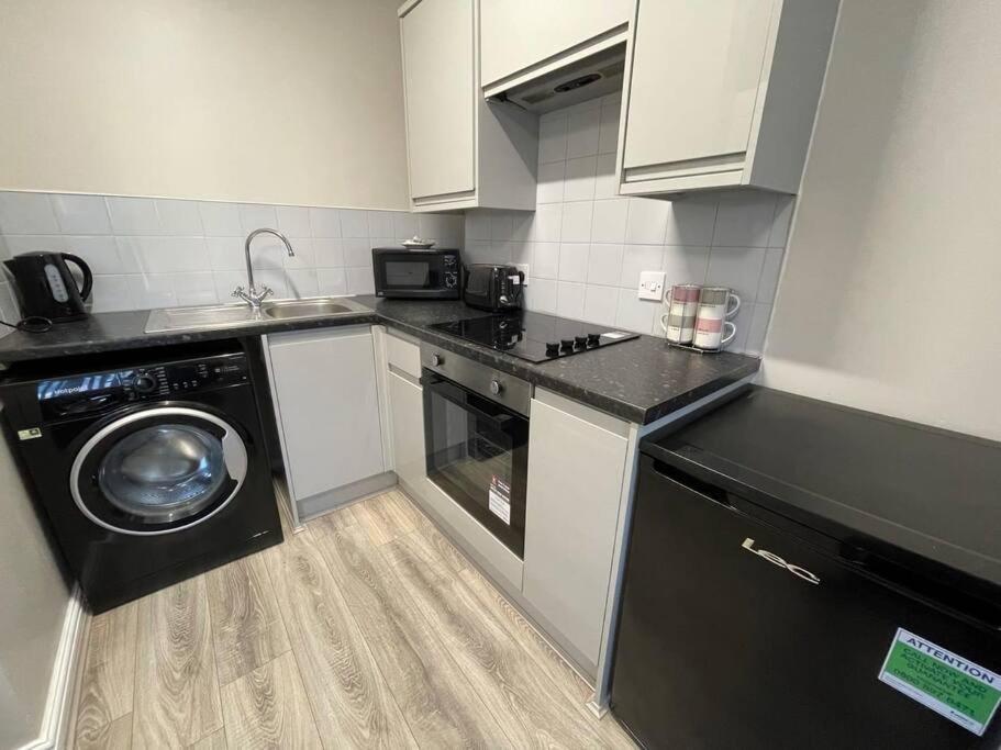a kitchen with a washing machine and a washer at Hosted By Ryan - 1 Bedroom Apartment in Liverpool