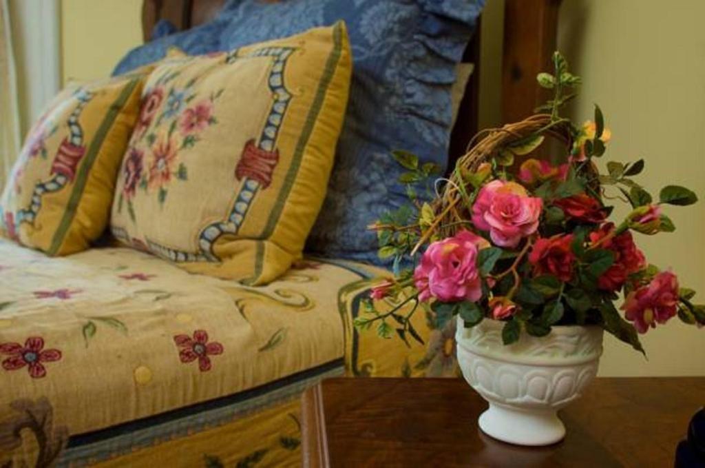 a vase with flowers on a table next to a couch at Lookaway Inn in North Augusta