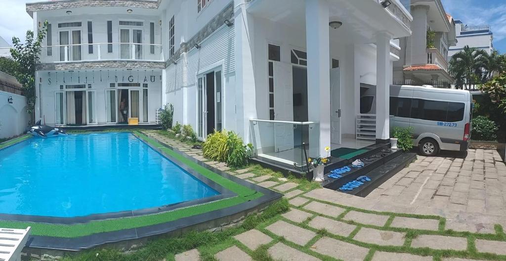 a house with a blue swimming pool in front of it at Rio 6a homestay in Vung Tau