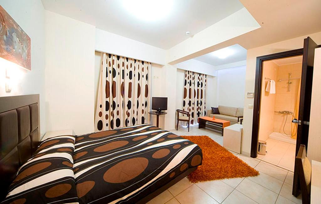 a bedroom with a bed and a living room at Hotel Astron in Karditsa