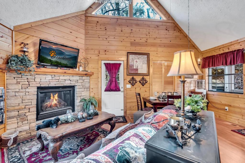 a living room with a fireplace in a log house at Amberwood- Get 951 worth of FREE area attraction tickets for each paid day!!! in Sevierville