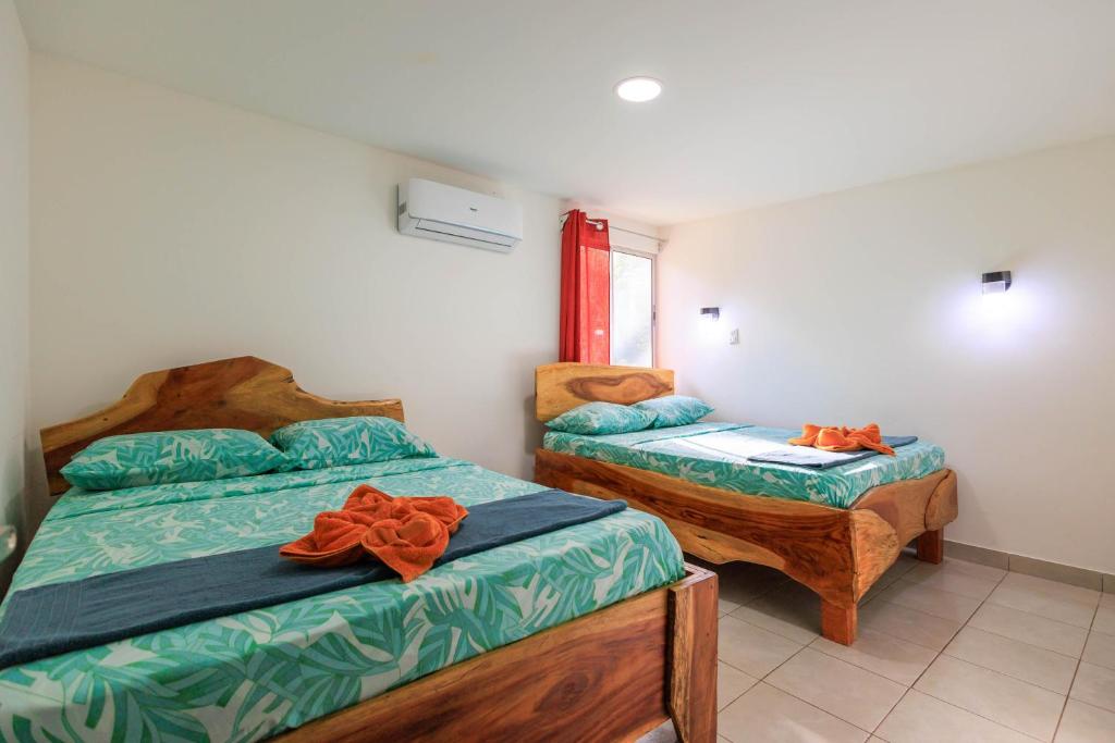 a bedroom with two beds and a window at Hotel Boutique D Angelo in Manzanillo