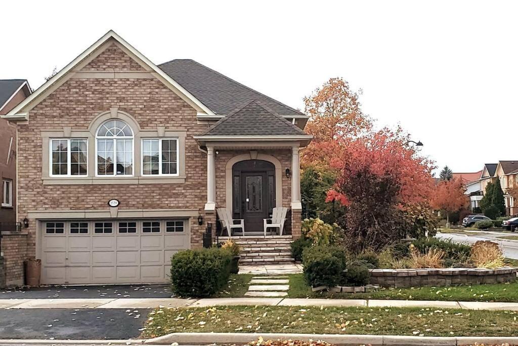 a brown brick house with a garage at Modern & Spacious 2 Bedrooms+2 Bathrooms Bungalow in Oakville in Oakville