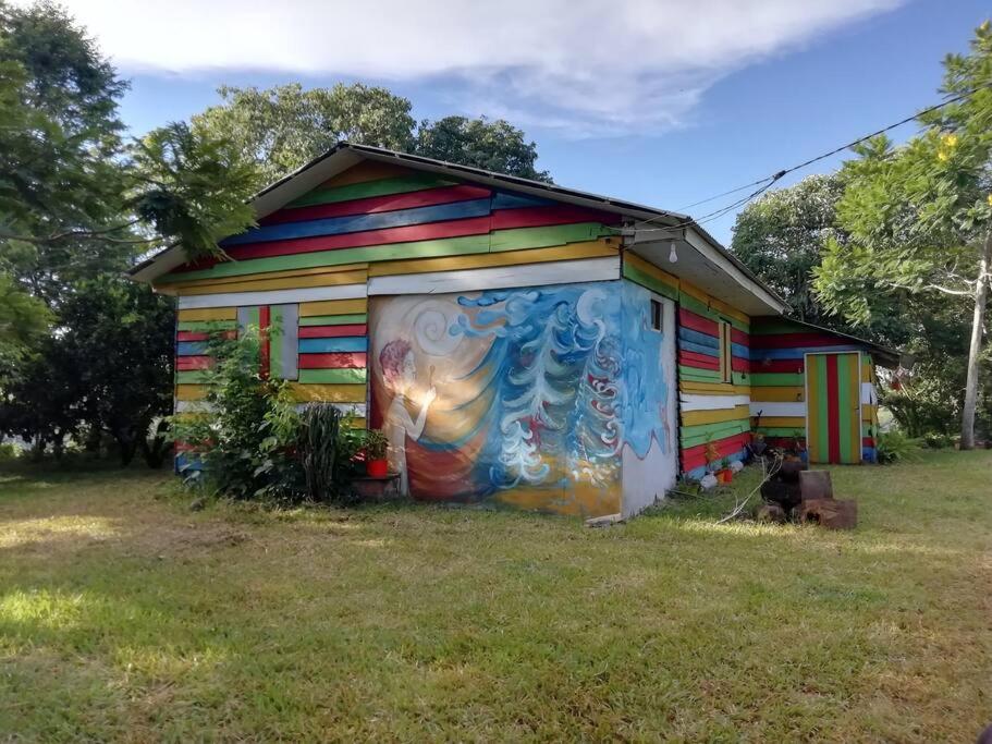a colorful house with a painting on the side of it at La Casa de Colores in Garuhapé