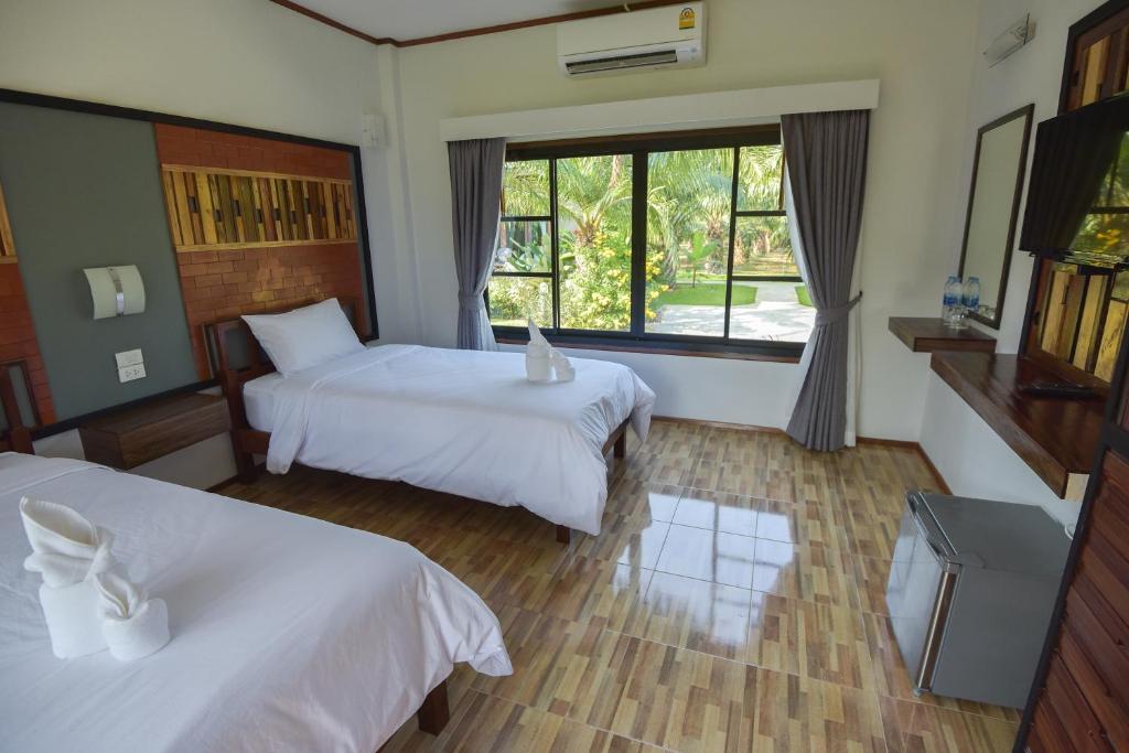 Postel nebo postele na pokoji v ubytování Palm Pran Resort