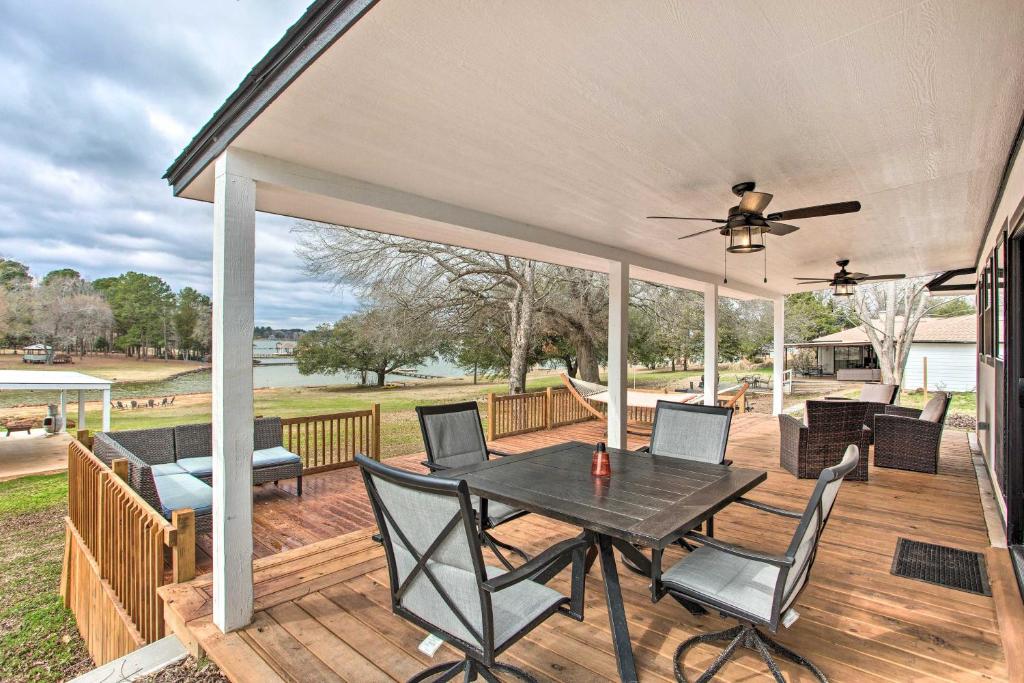 a patio with a table and chairs on a deck at Lakefront Frankston Home with Guest Studio! in Coffee City
