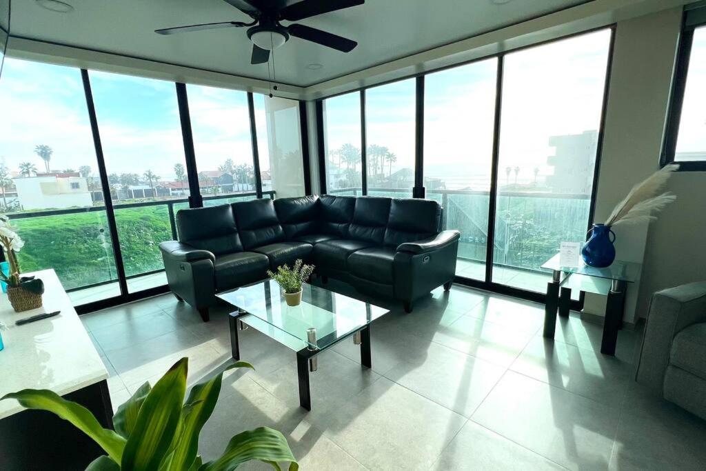 a living room with a couch and a table at Luxury 2BR Condo Rosarito (E) in Rosarito