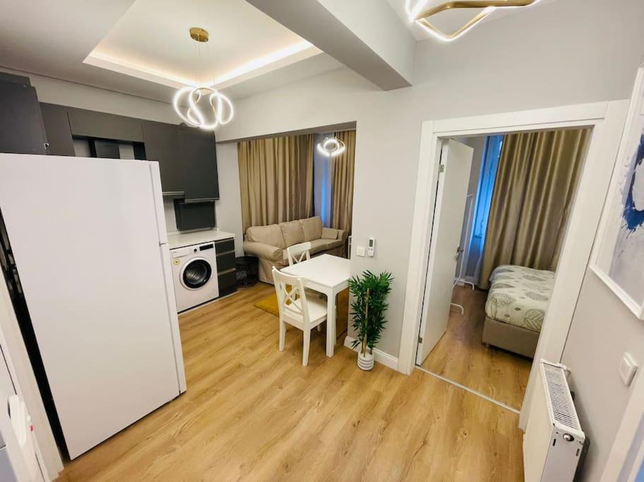 a small living room with a table and a couch at Private Apt, 2 mins to Transp. in Istanbul
