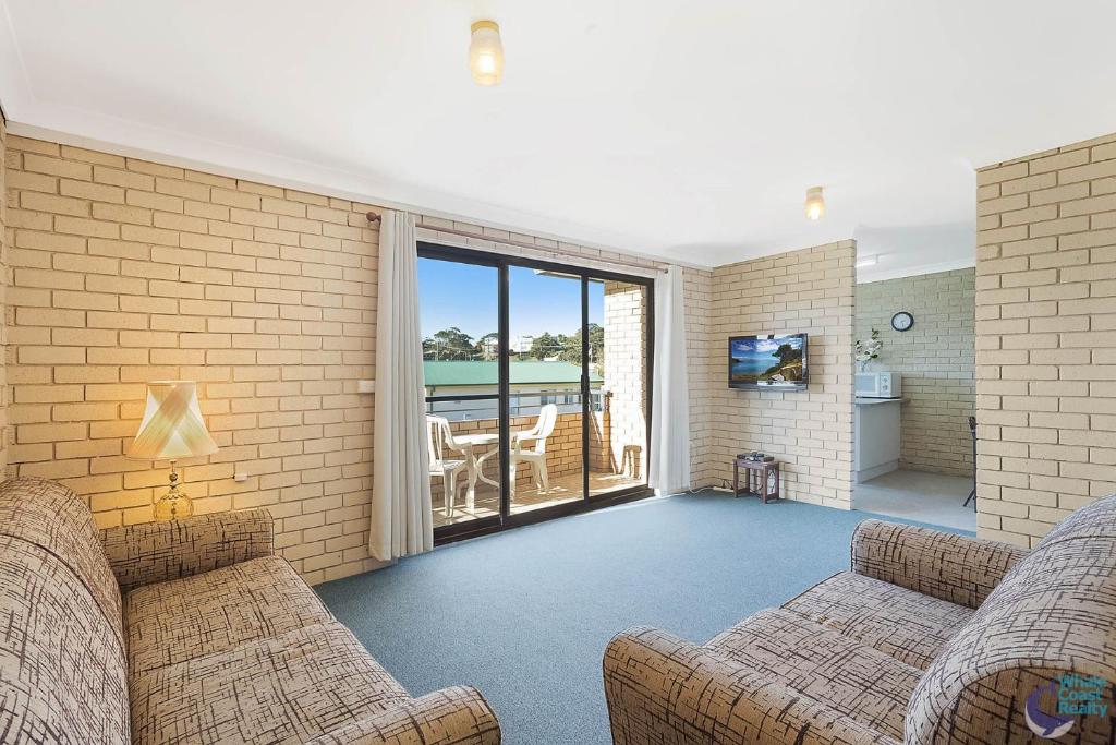 a living room with two couches and a balcony at Apollo Unit 30 First Floor in Narooma