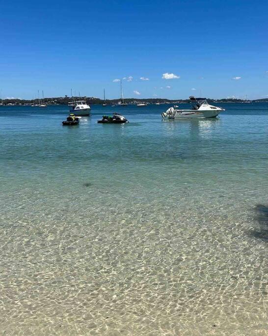 a group of boats in a large body of water at HighTide- luxury apartment, almost on the beach. in Corlette