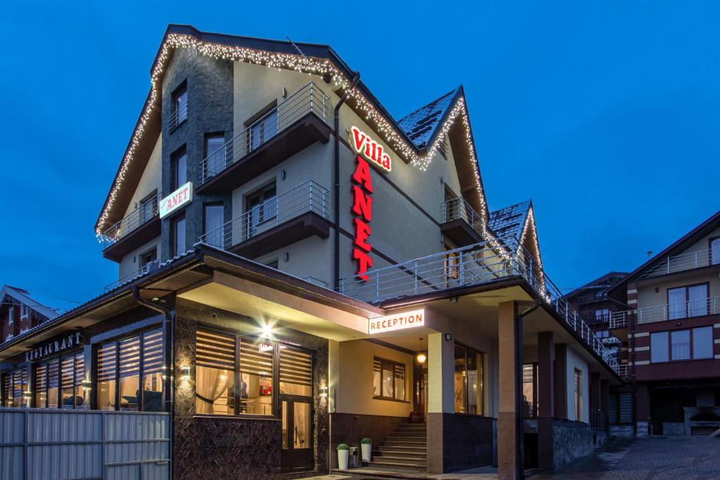 a building with a sign that reads hotel at Villa Anet in Bukovel