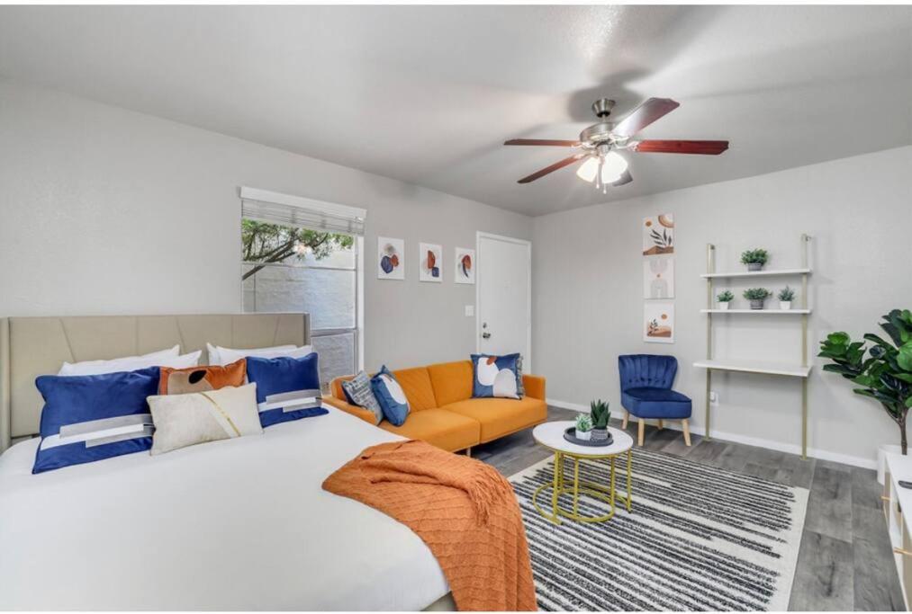 a bedroom with a bed and a couch and a ceiling fan at Cozy 1BR sleep 6+ Free Parking in Phoenix