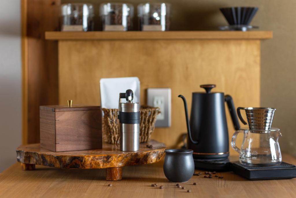 a table with a wooden tray with various items on it at TEMPLESTAY ZENSŌ in Chiyodamachi