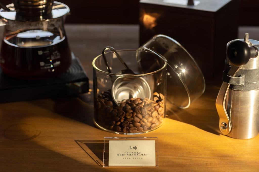 a glass jar filled with coffee beans on a table at TEMPLESTAY ZENSŌ in Chiyodamachi