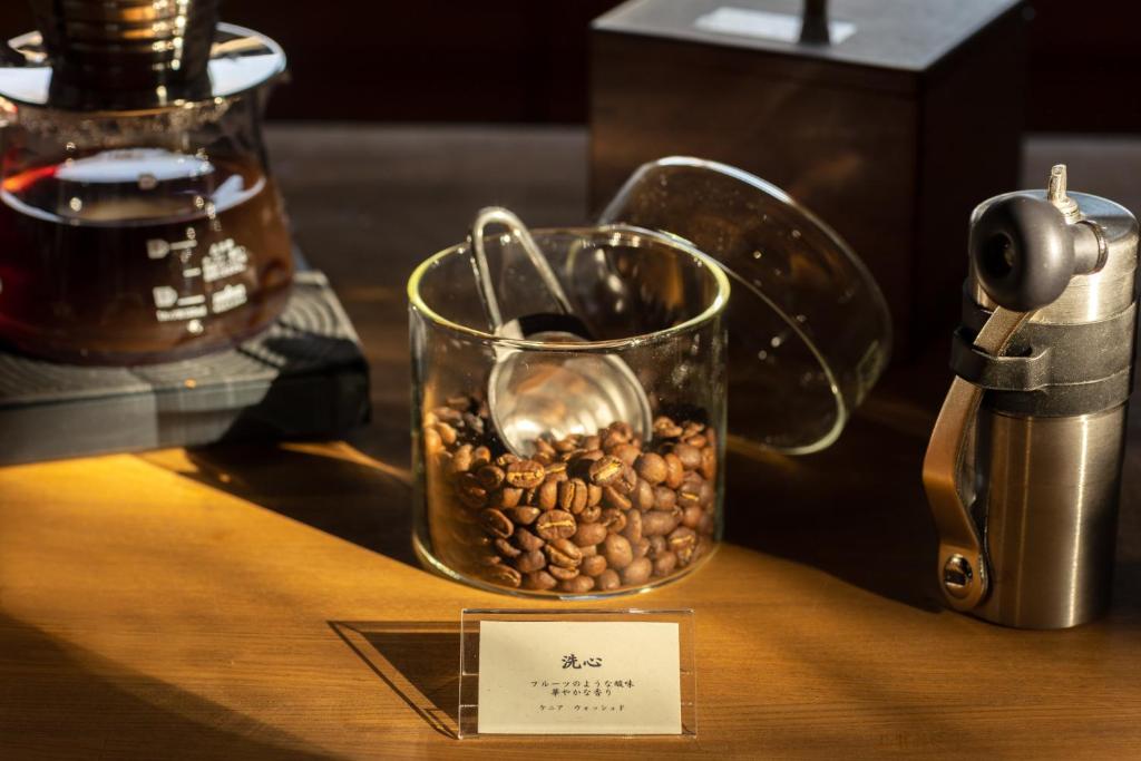 a jar of coffee beans sitting on a table at TEMPLESTAY ZENSŌ in Chiyodamachi