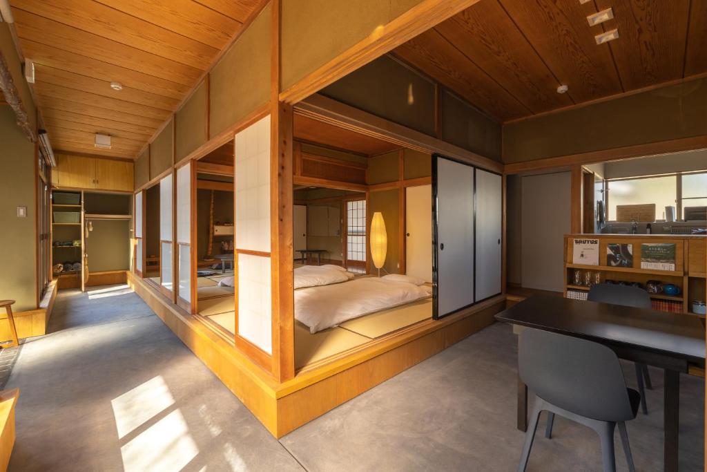 a bedroom in a house with a bed in the middle at TEMPLESTAY ZENSŌ in Chiyodamachi