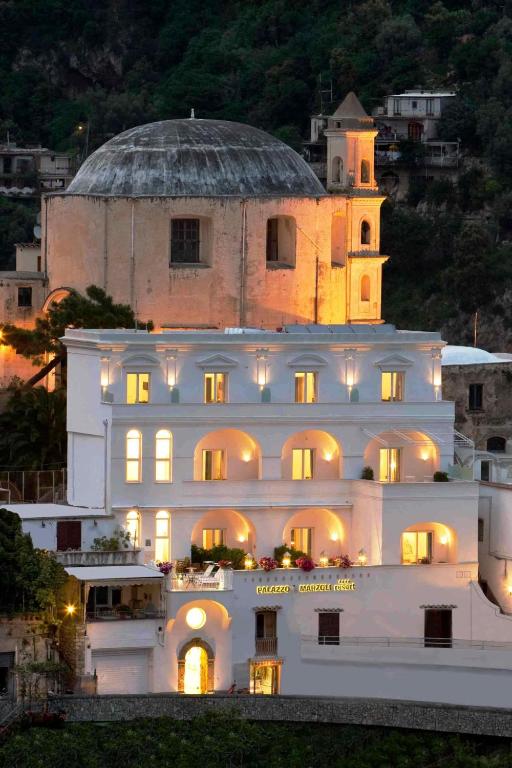 a large white building with its lights on at Palazzo Marzoli charme Resort - Small Luxury Hotel in Positano