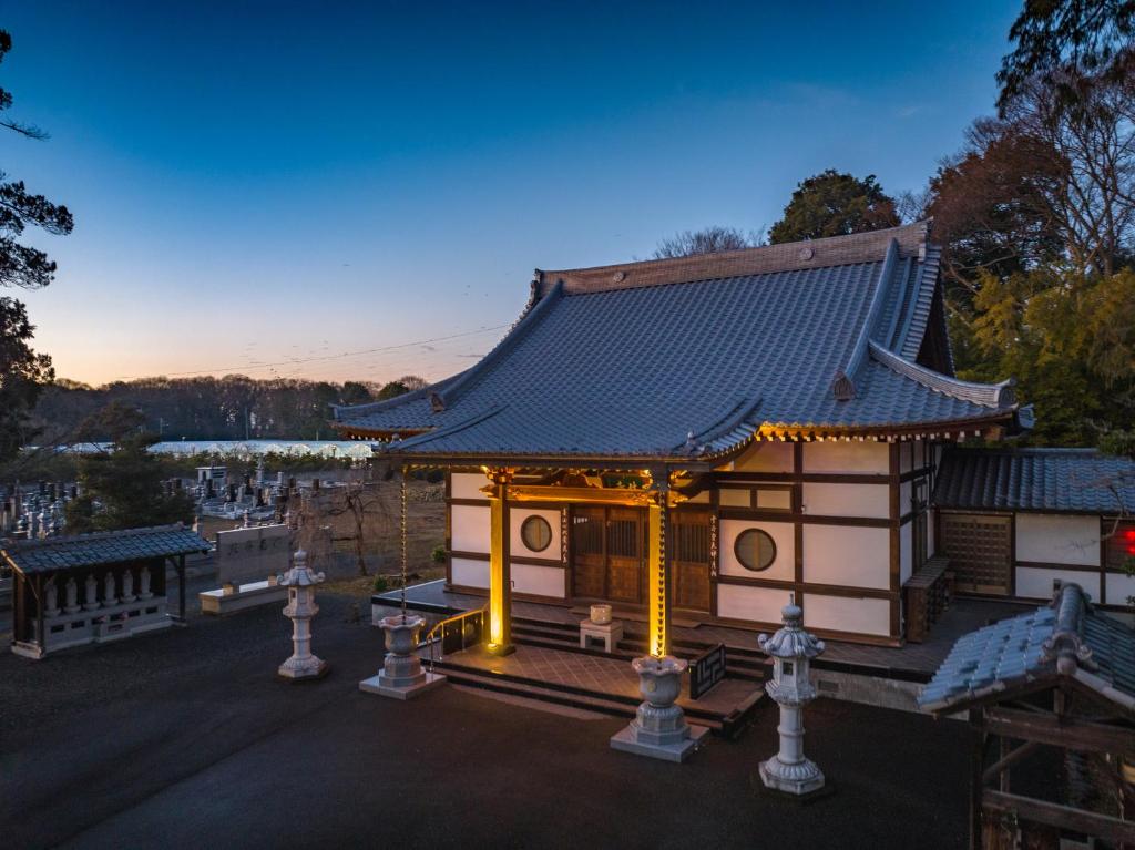 a temple in a park with lights on at TEMPLESTAY ZENSŌ in Chiyodamachi