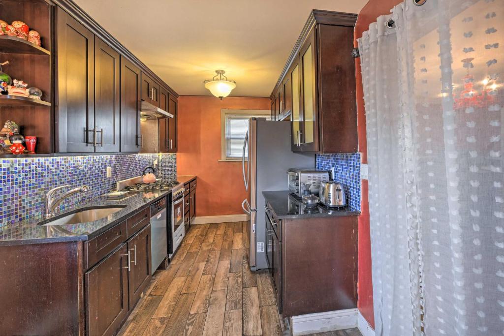 a kitchen with a sink and a refrigerator at Charming New York Escape Near Central Park! in Jericho