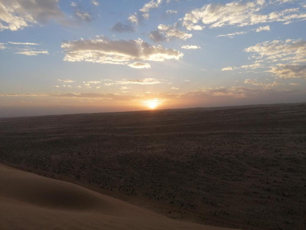 a sunset in the middle of the desert at Moon Light Camp in Bidiyah