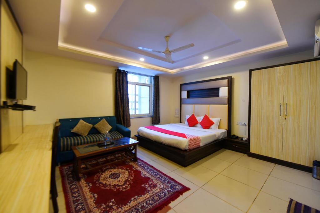 a hotel room with a bed and a couch at Collection O Tip Top in Jaipur