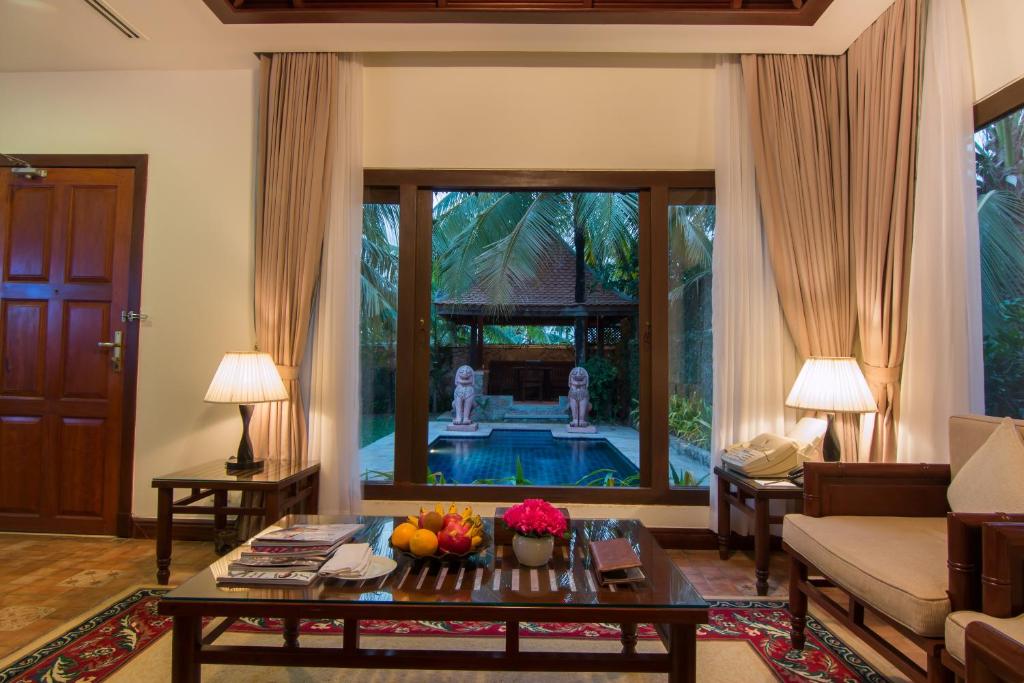 a living room with a couch and a table at Palace Residence & Villa Siem Reap in Siem Reap