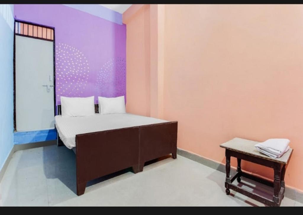 a small bedroom with a bed and a table at Hotel Radhe Inn By WB Inn in Agra