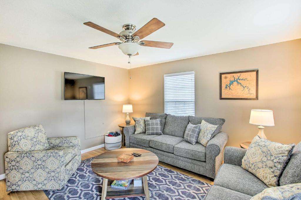 a living room with a couch and a ceiling fan at Welcoming Byrdstown Home Walk to Main St! in Byrdstown