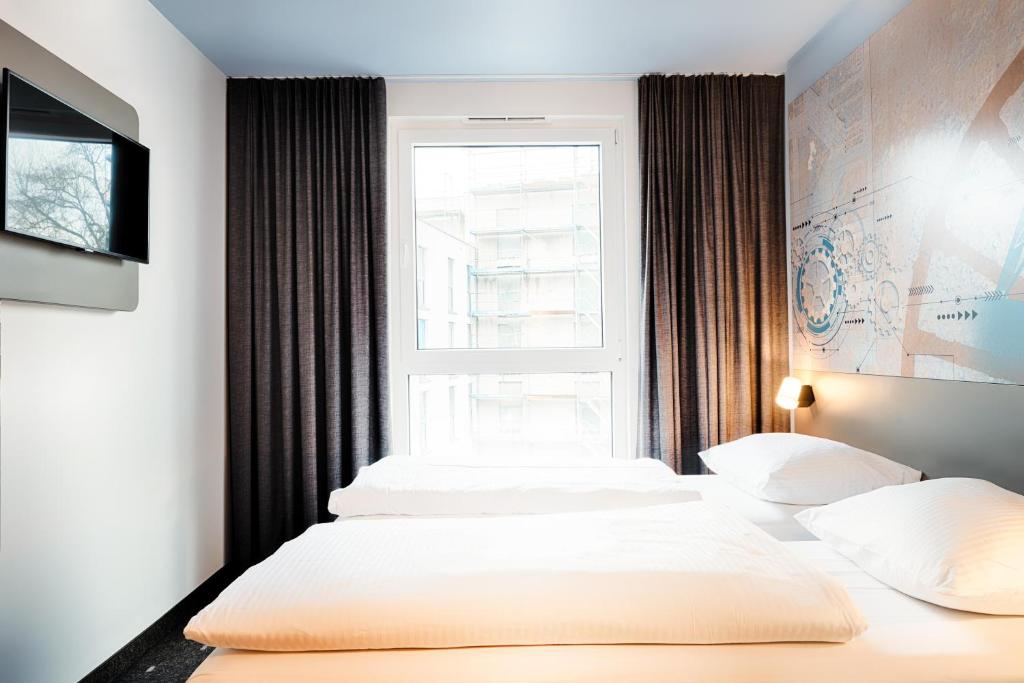 Postel nebo postele na pokoji v ubytování B&B Hotel Bochum-City