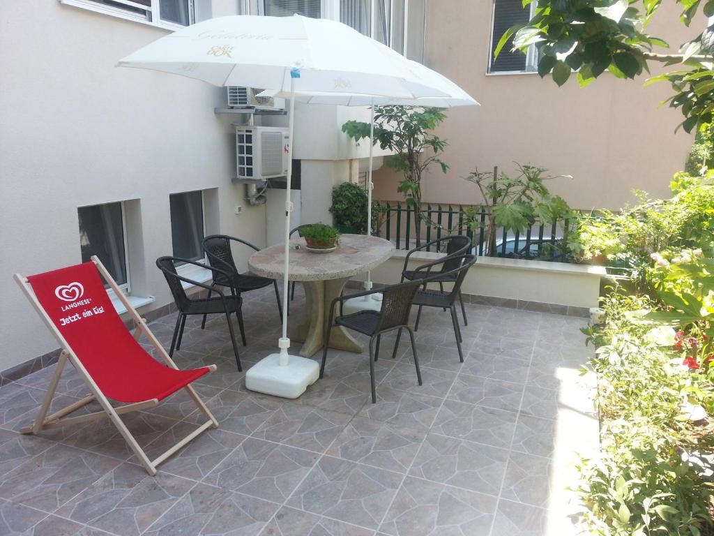 a table and chairs with an umbrella on a patio at 4 seasons in Split