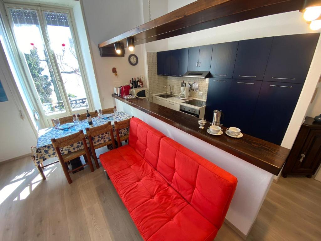 a living room with a red couch in a kitchen at Gardenia in Oggebbio