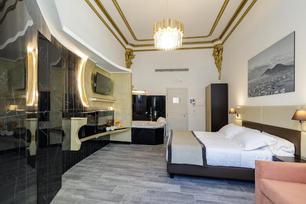 a hotel room with a bed and a bathroom at Hotel Palazzo Argenta in Naples
