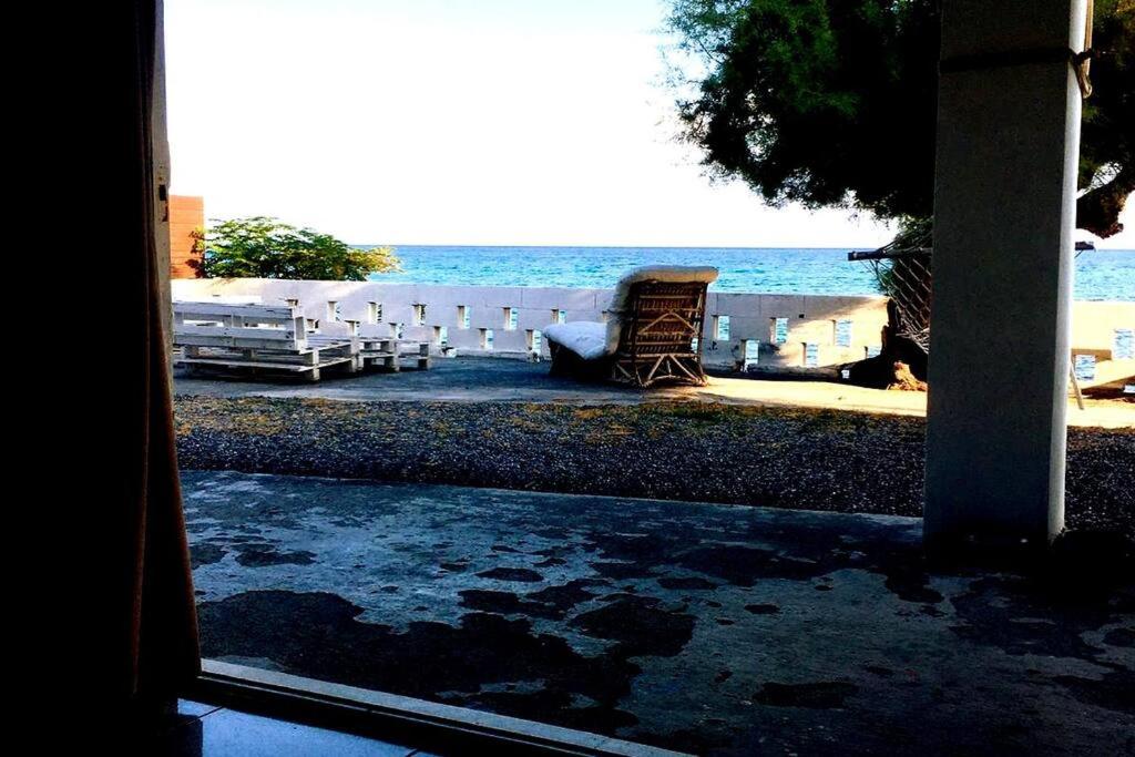 a view of the beach from the porch of a house at High By The Beach House in Girne in Ayyorgi
