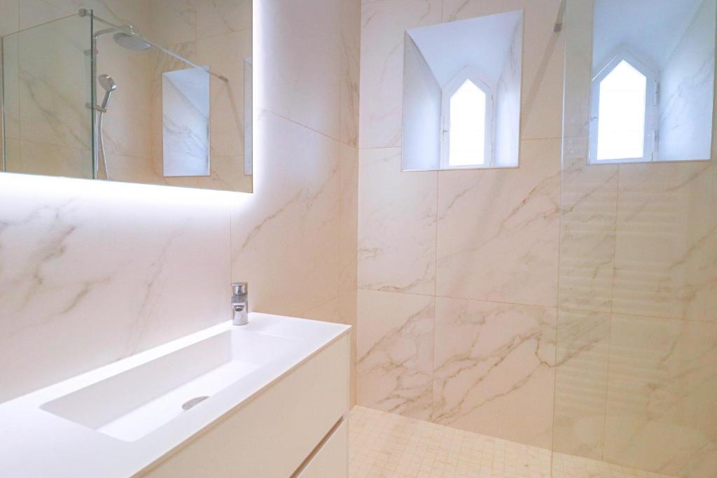 a white bathroom with a tub and a sink at NAPOLEON Luxurious renovated apartment 1min from Palais in Cannes