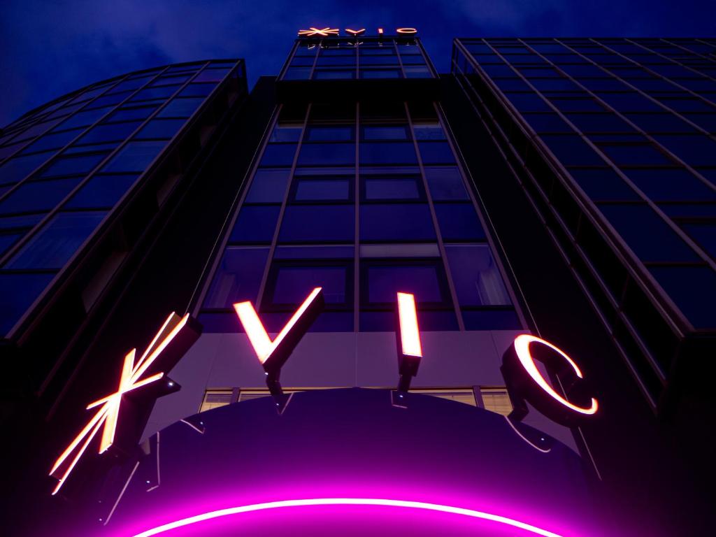 a building with a neon sign in front of it at Hotel VIC in Leiden