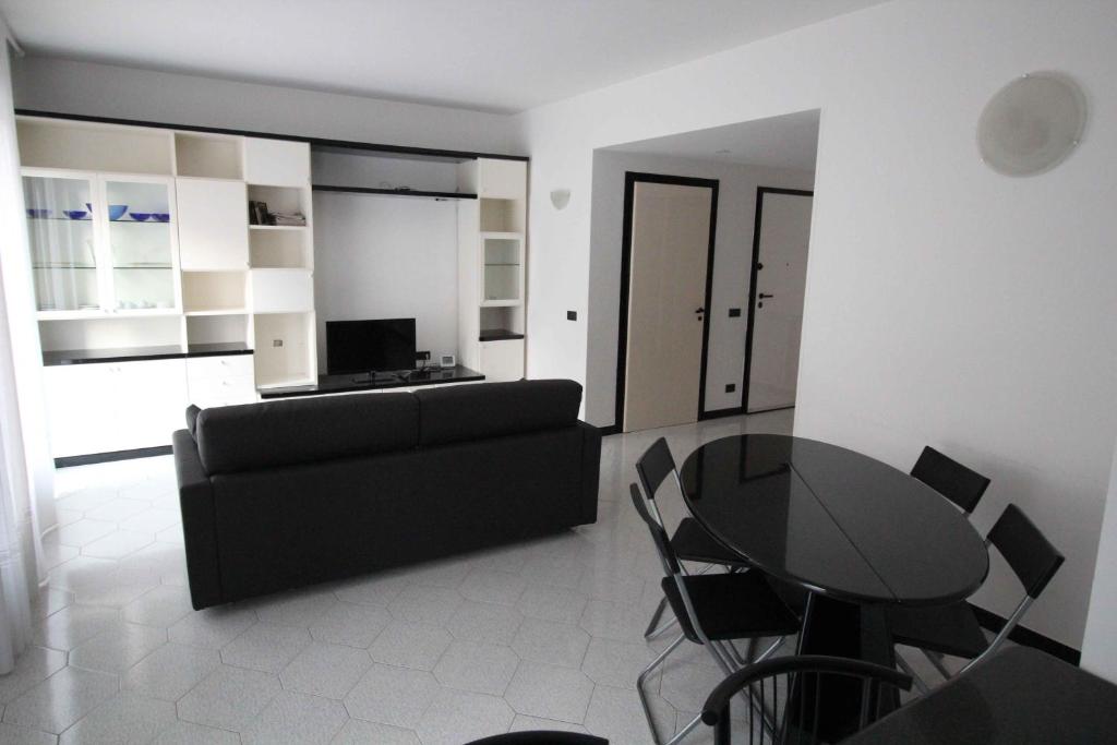 a living room with a black couch and a table at Miramare in Arma di Taggia